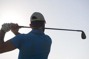 golf player hitting shot photo