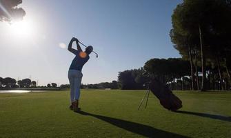 golf player hitting shot photo