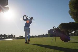 golf player hitting shot photo