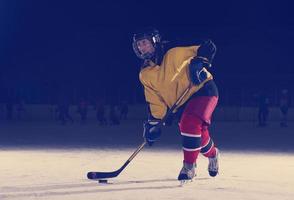 teen ice hockey player in action photo