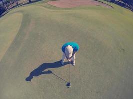 top view of golf player hitting shot photo