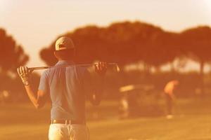 golfer from back at course looking to hole in distance photo