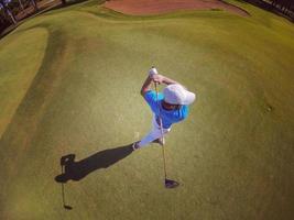 top view of golf player hitting shot photo