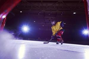 teen ice hockey player in action photo