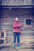 young hipster in front of wooden house photo