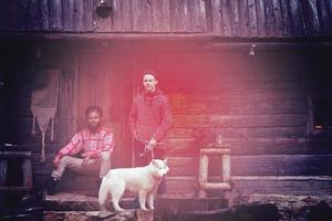 frineds together in front of old wooden house photo