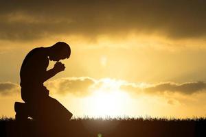 Silhouette of Christian Praying Hands Spiritual and Religious People Praying to God Christianity Concepts photo