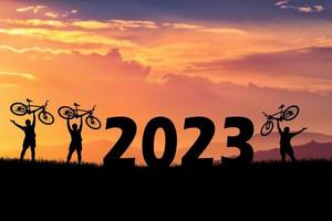 Bicycle adventurous tourists carrying bicycles over obstacles. happy new year 2023 photo