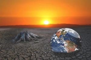 The concept of global warming and drought and poverty and food shortages. Arid soils with hot climates have a globe that lacks green space. photo