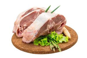 Raw lamb on wooden board and white background photo