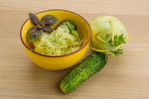 Kohlrabi salad on wooden background photo