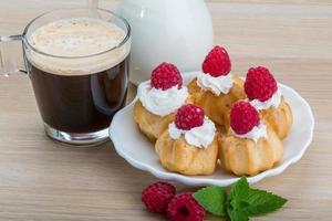 Profiterole with raspberry photo