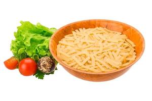 Raw pasta in a bowl on white background photo