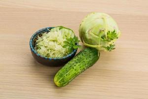 Kohlrabi salad on wooden background photo