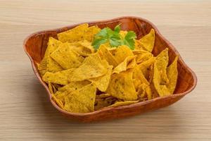 Nachos in a bowl on wooden background photo