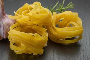 Tagliatelle on wooden background photo