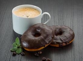 Chocolate donuts on wooden background photo