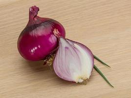 Red onion on wooden background photo