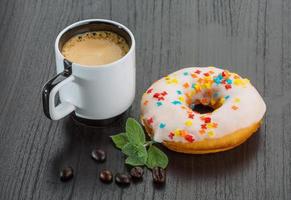 Coffee with donuts on wooden background photo