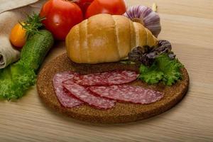 Salami on wooden plate photo