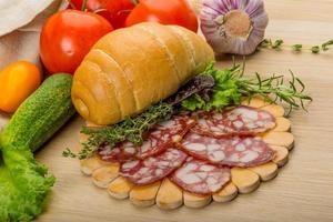 Salami on wooden plate photo