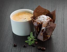 Coffee with muffin on wooden background photo