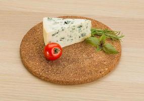 Blue cheese on wooden background photo