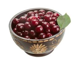 Cherry in the bowl on white background photo