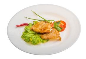 Baracuda steak on the plate and white background photo