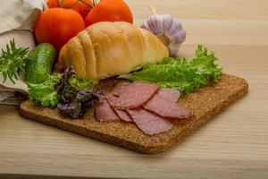 Salami sausages on wooden plate photo