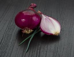 Red onion on wooden background photo