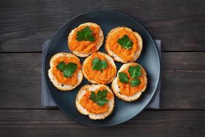 Sandwiches with bread zucchini caviar tomatoes onions. Homemade vegetarian food. Canned stewed vegetable. wooden background top view, copy space photo