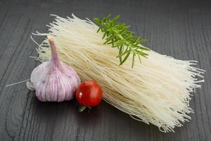 Rice noodles on wooden background photo