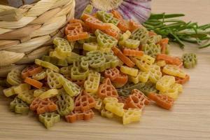 Kids pasta on wooden background photo