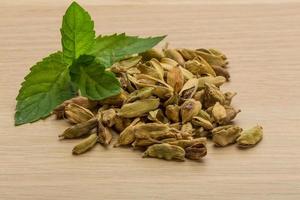 Cardamom on wooden background photo