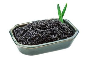 Black caviar in a bowl on white background photo