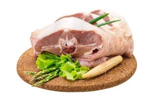 Raw lamb on wooden board and white background photo