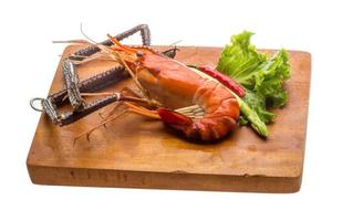 Giant Freshwater Prawn on wooden plate and white background photo