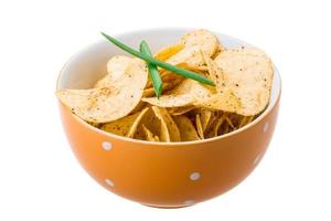 Potato chips in a bowl on white background photo