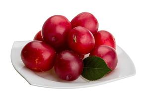 Damson plum on the plate and white background photo