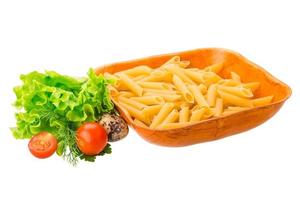 Raw pasta in a bowl on white background photo