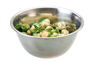 Crispy green peas in a bowl on white background photo