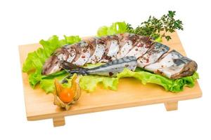 Mackerels on wooden board and white background photo