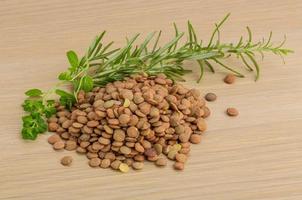 Raw lentils on wooden background photo