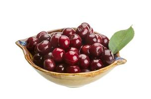 Cherry in the bowl on white background photo