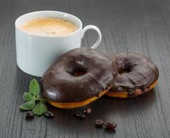 Chocolate donuts on wooden background photo