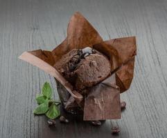 Chocolate muffin on wooden background photo