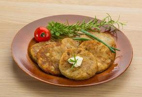 Hash brown on the plate and wooden background photo