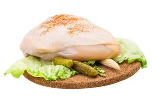 Chicken breast on wooden board and white background photo