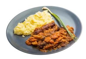 Dublin coddle on the plate and white background photo